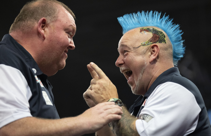 Peter Wright and John Henderson celebrate at the Cazoo World Cup
