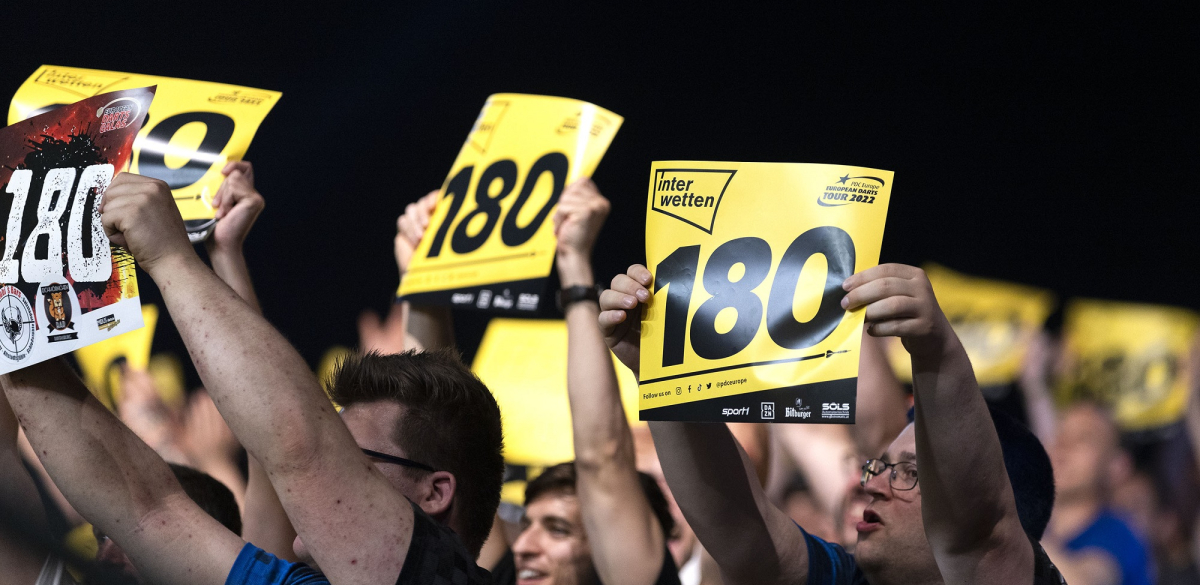 Fans holding up 180 cards at a PDC European Tour event