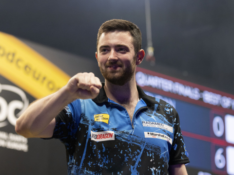 Luke Humphries celebrates winning a match at European Darts Grand Prix