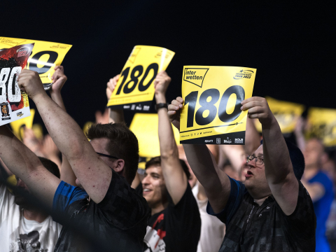 Fans holding up 180 cards at a PDC European Tour event