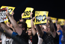Fans holding up 180 cards at a PDC European Tour event